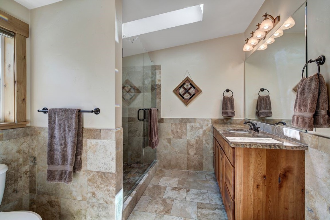 379 Hummingbird Circle Silverthorne, CO 80498 - Photo 14 of 44 a bathroom with a sink a mirror and shower