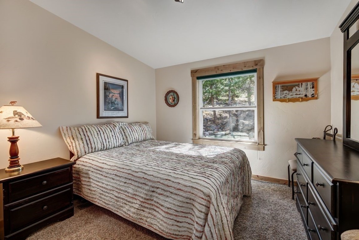 379 Hummingbird Circle Silverthorne, CO 80498 - Photo 15 of 44 a bedroom with a bed and a window
