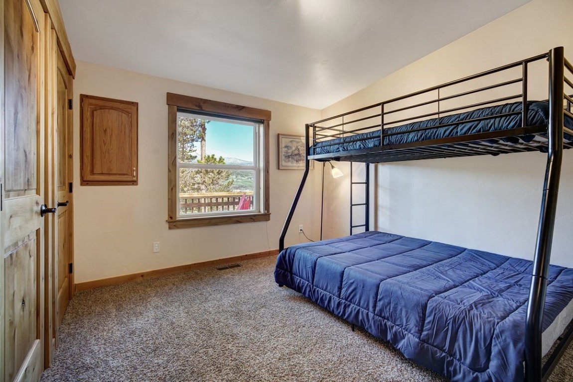 379 Hummingbird Circle Silverthorne, CO 80498 - Photo 18 of 44 a bedroom with a bed and a window