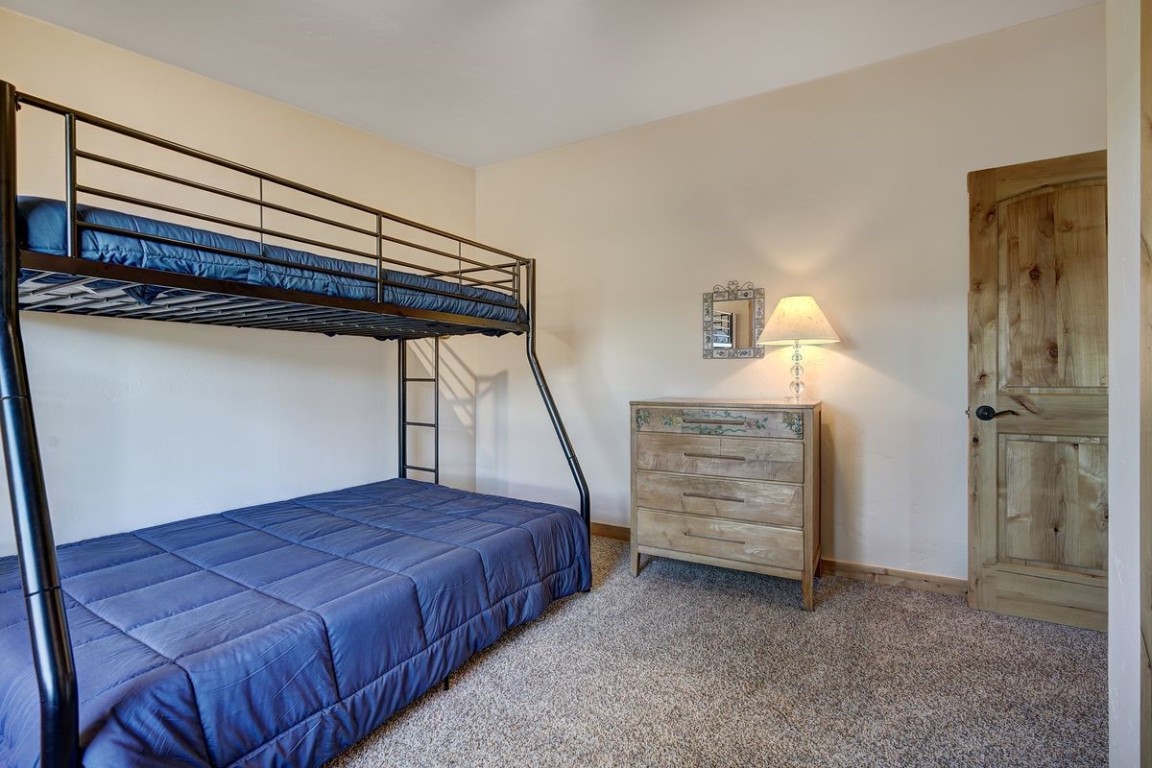 379 Hummingbird Circle Silverthorne, CO 80498 - Photo 19 of 44 a bedroom with a bed and cabinets