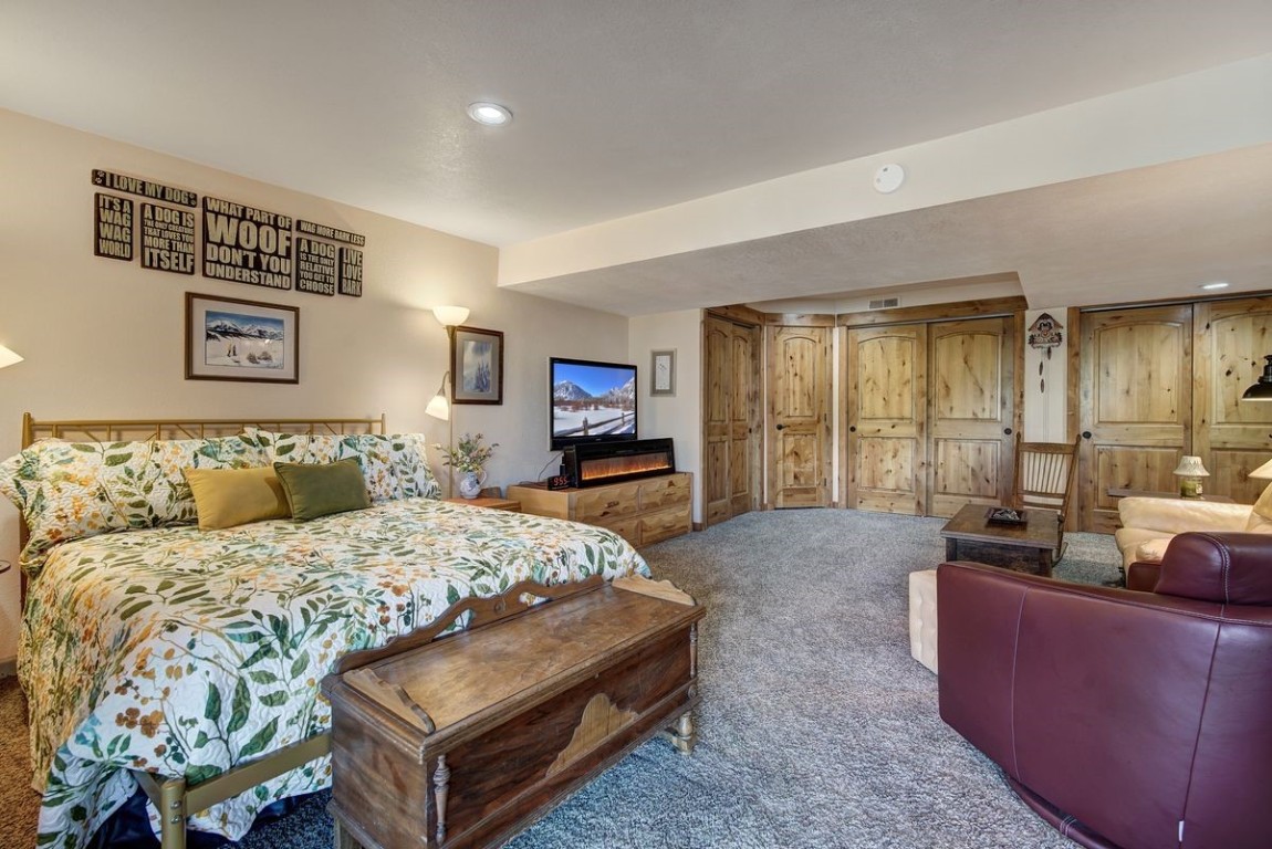 379 Hummingbird Circle Silverthorne, CO 80498 - Photo 24 of 44 a bedroom with a large bed and furniture