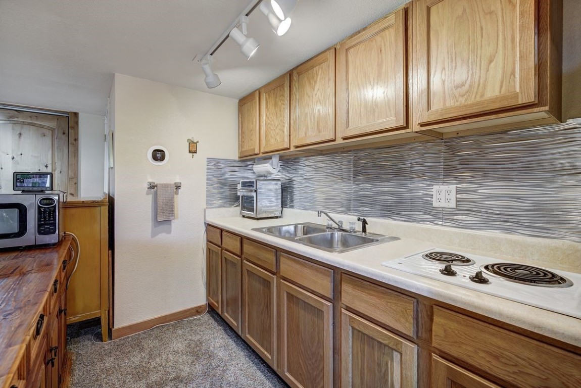 379 Hummingbird Circle Silverthorne, CO 80498 - Photo 27 of 44 a kitchen with stainless steel appliances granite countertop a sink stove and refrigerator