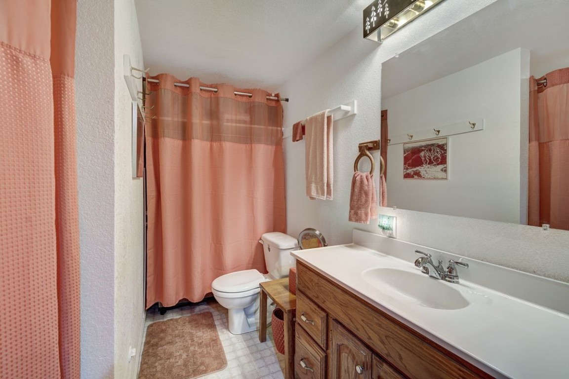 379 Hummingbird Circle Silverthorne, CO 80498 - Photo 28 of 44 a bathroom with a granite countertop sink and a mirror