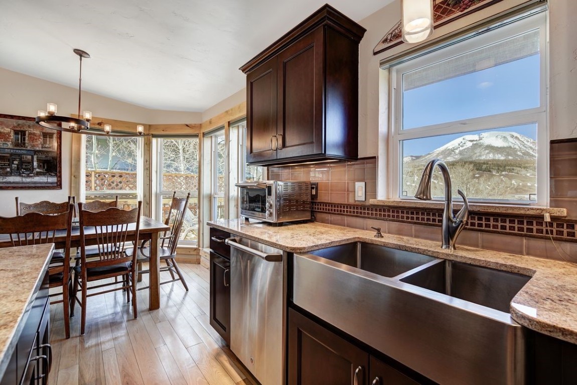 379 Hummingbird Circle Silverthorne, CO 80498 - Photo 7 of 44 a kitchen that has a sink a counter top space appliances and cabinets