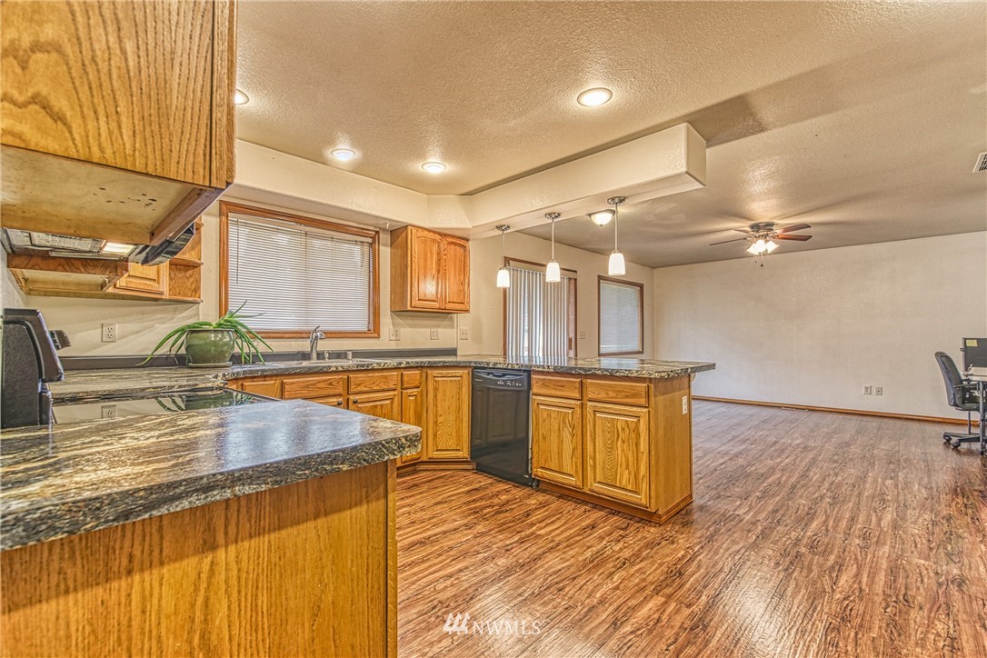 18212 Empire Street Southwest Rochester, WA 98579 - Photo 11 of 29 a view of a kitchen with kitchen island a large counter top space a sink stainless steel appliances and cabinets