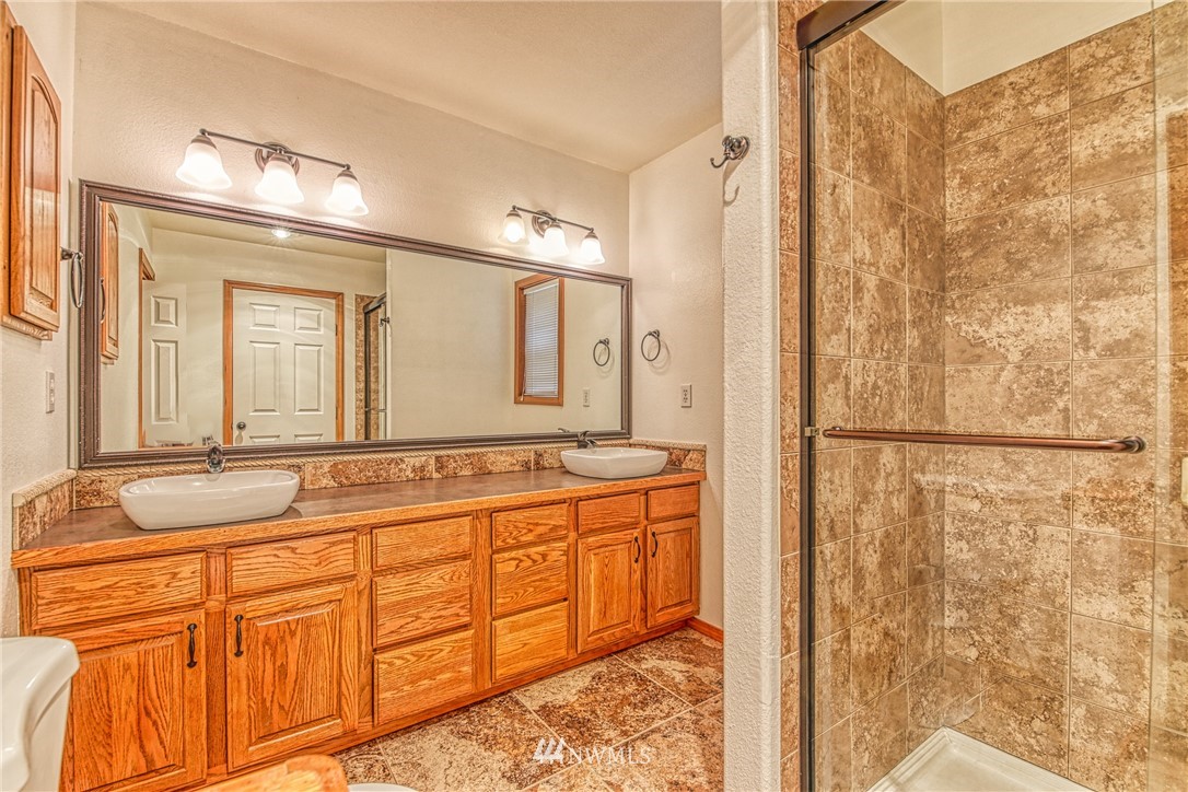 18212 Empire Street Southwest Rochester, WA 98579 - Photo 16 of 29 a bathroom with a granite countertop sink and a mirror