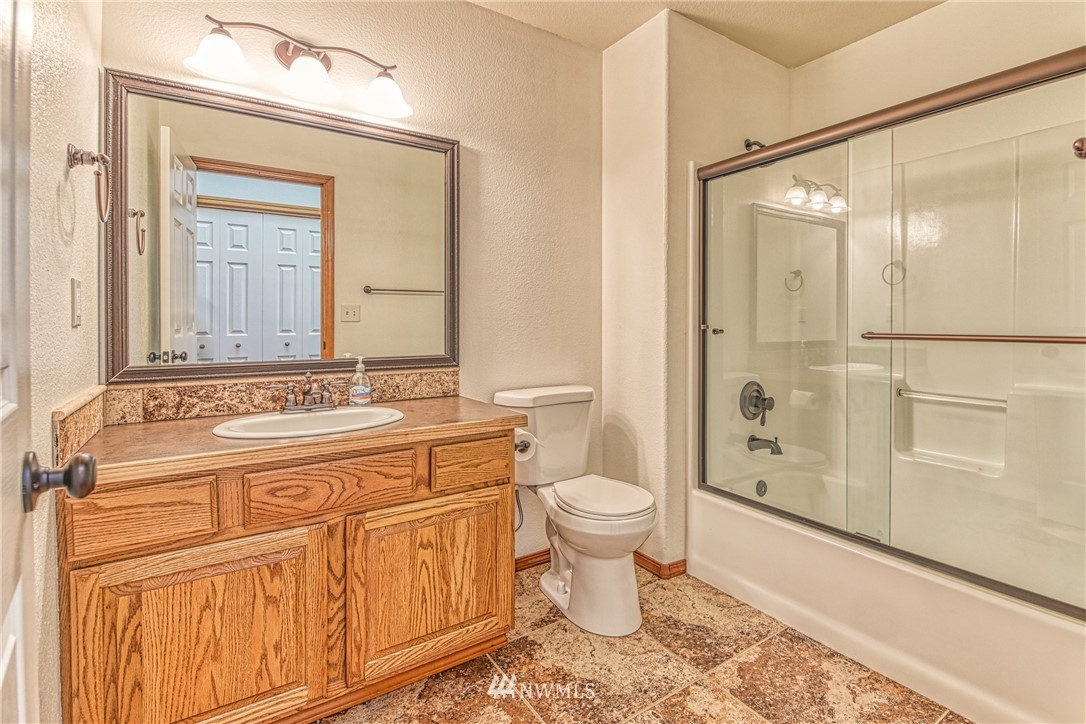 18212 Empire Street Southwest Rochester, WA 98579 - Photo 20 of 29 a bathroom with a sink toilet a mirror and shower