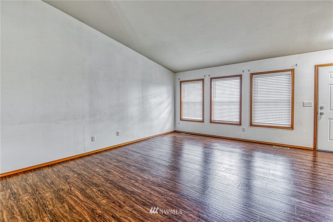 18212 Empire Street Southwest Rochester, WA 98579 - Photo 27 of 29 a view of an empty room with wooden floor and window