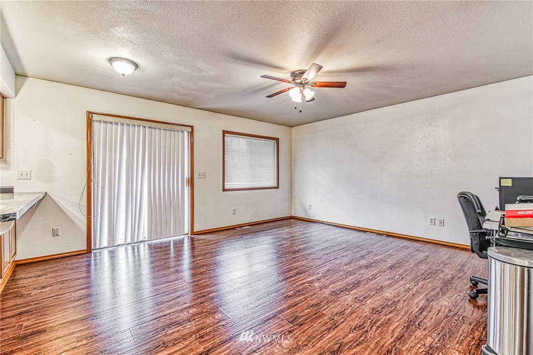 18212 Empire Street Southwest Rochester, WA 98579 - Photo 28 of 29 a view of an empty room with wooden floor and a window
