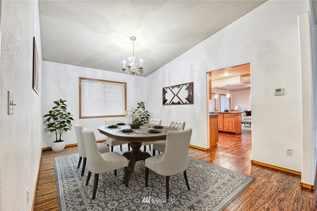 18212 Empire Street Southwest Rochester, WA 98579 - Photo 6 of 29 a view of a dining room with furniture and wooden floor