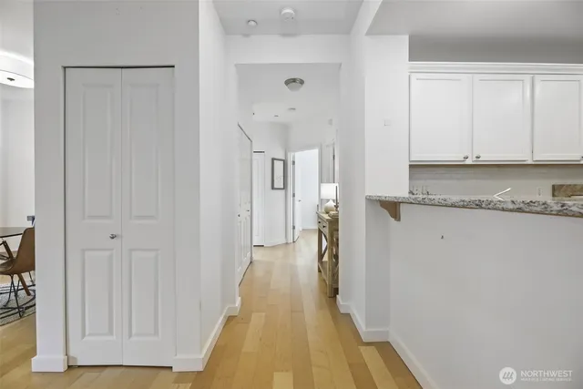 a view of a hallway with granite countertop a hallway and a refrigerator