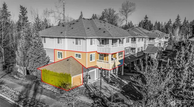 an aerial view of a house with table and chairs