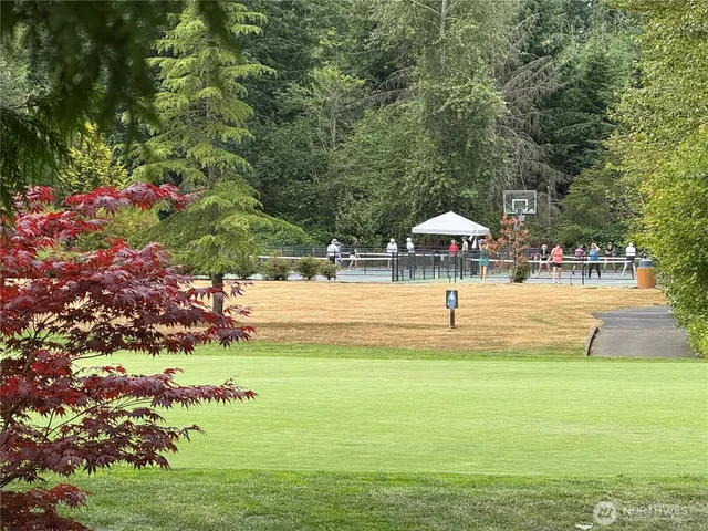a swimming pool with trees in the background
