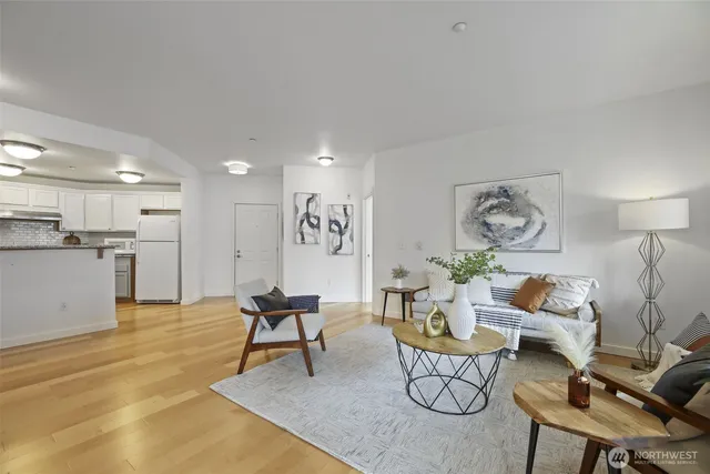a living room with furniture and kitchen view