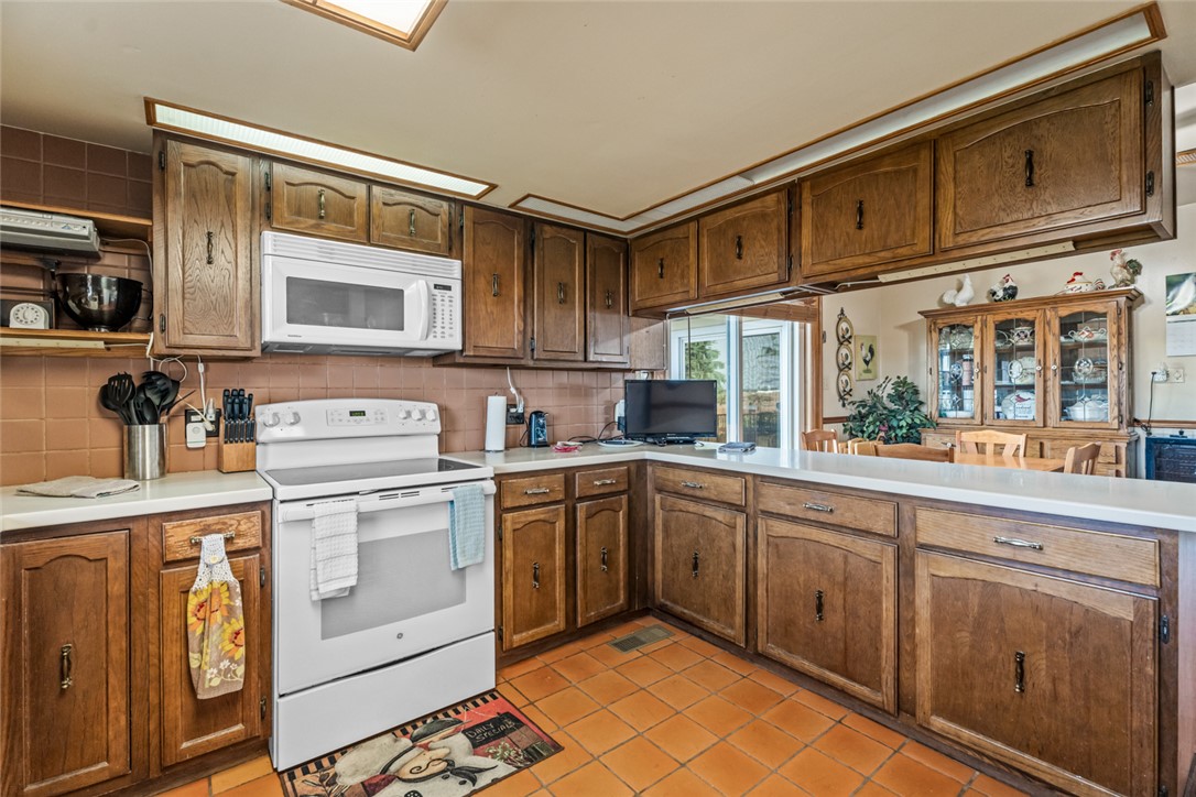 7404 Grubbs-Rex Road Arcanum, OH 45304 - Photo 10 of 40 This spacious kitchen offers ample cabinetry and an inviting breakfast bar.