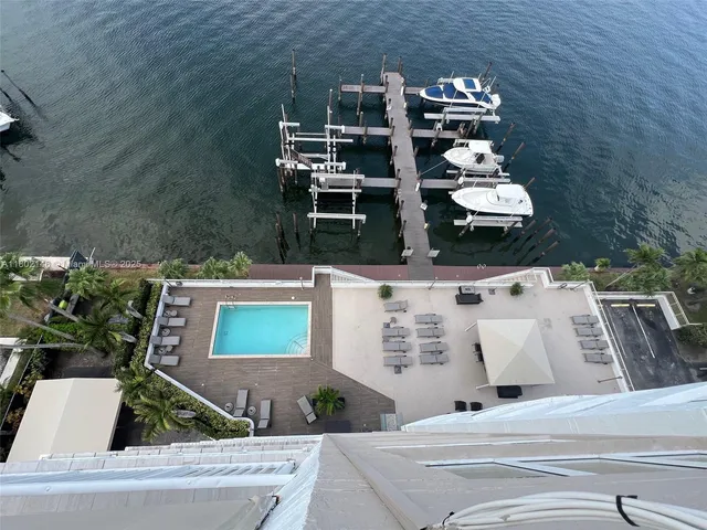 a living room with furniture kitchen view and a window