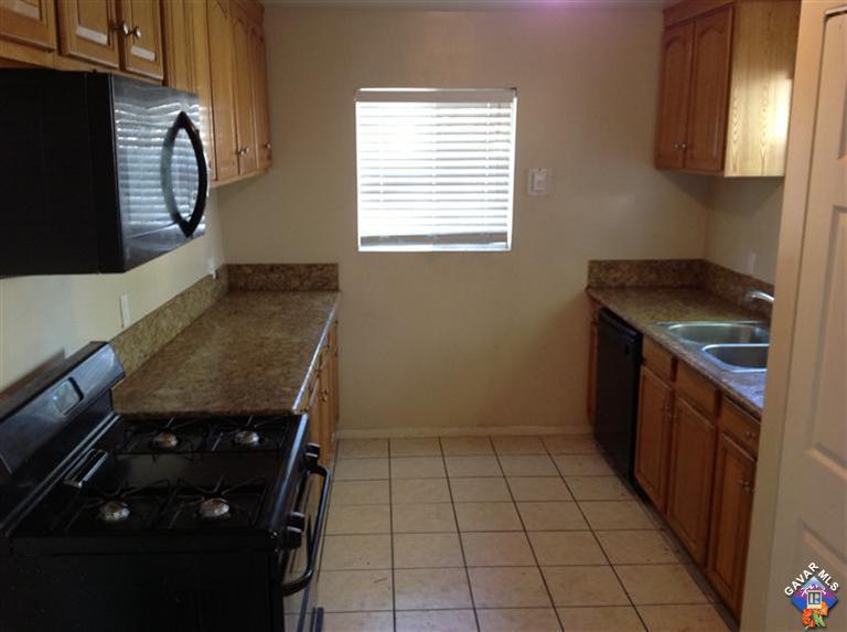 45256 Kingtree Avenue Lancaster, CA 93534 - Photo 3 of 8 a kitchen with a stove a sink and a microwave