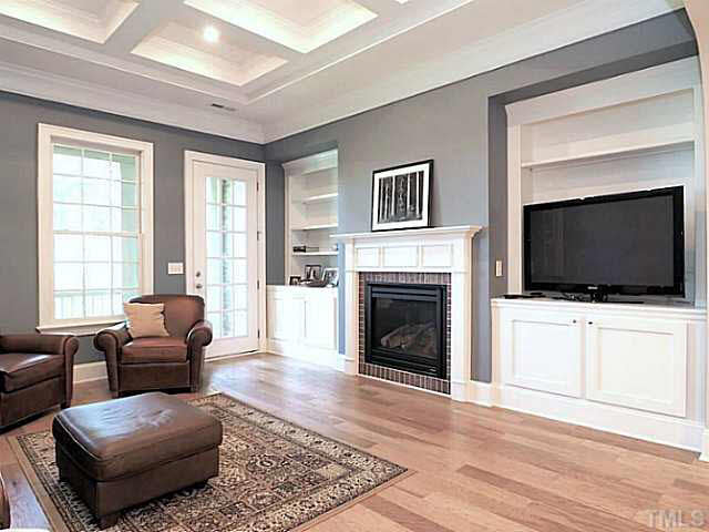 3830 Cottage Rose Lane Raleigh, NC 27612 - Photo 3 of 23 Gorgeous Details _ Direct Vent Raised Fireplace with Gas Logs _ Granite Surround, Built-Ins and Coffered Ceiling. Door Leads to Covered Porch.