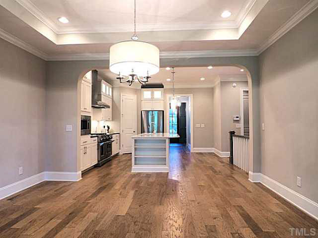 3830 Cottage Rose Lane Raleigh, NC 27612 - Photo 22 of 23 View From Dining Room into Kitchen. Open Floor Plan _ Note Arched Doorways and Detailed Molding, Trey Ceiling and Lighting. 8'-2 Panel Smooth Doors Thru Home. Custom Casings Around Doors and Windows.