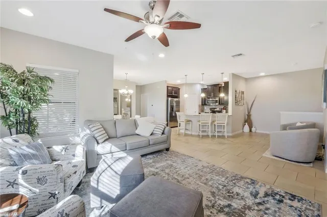 a living room with furniture and a chandelier