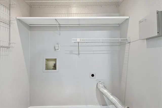 a kitchen with a dining table chairs and white cabinets with wooden floor