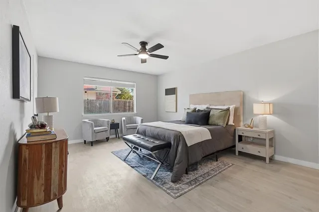 a spacious bedroom with a bed and a window