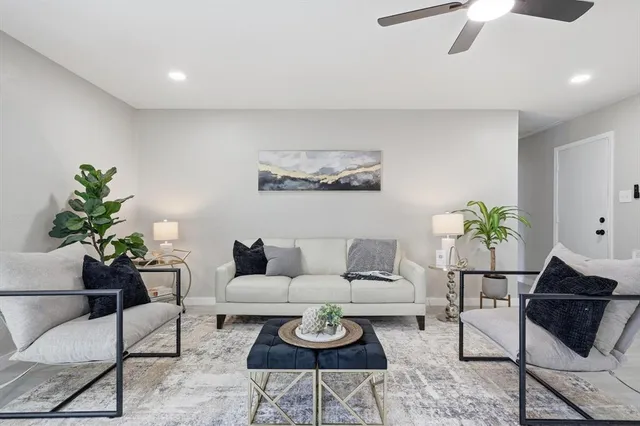a living room with furniture and a potted plant