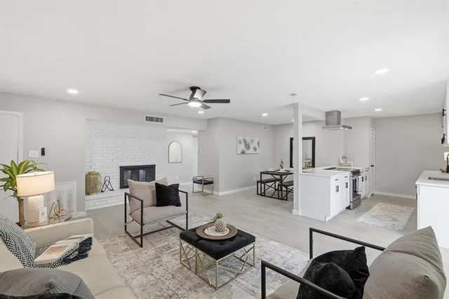 a living room with furniture and a wooden floor