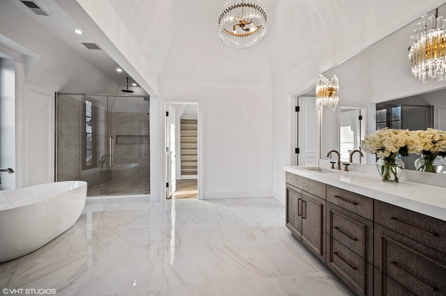 655 Sheridan Road Glencoe, IL 60022 - Photo 33 of 45 a spacious bathroom with a double vanity sink a large mirror and a shower