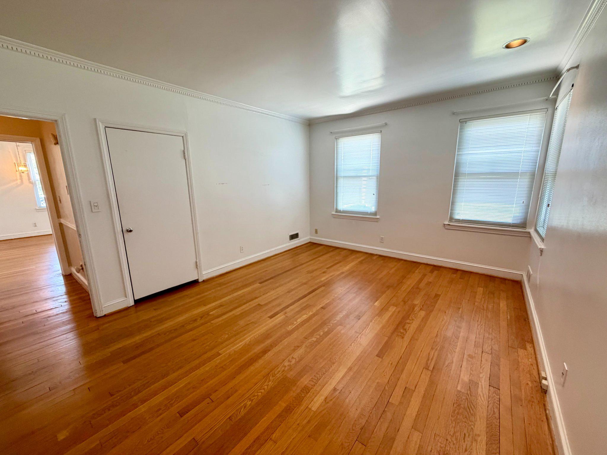 6318 Winner Avenue Baltimore, MD 21215 - Photo 34 of 75 an empty room with wooden floor and windows