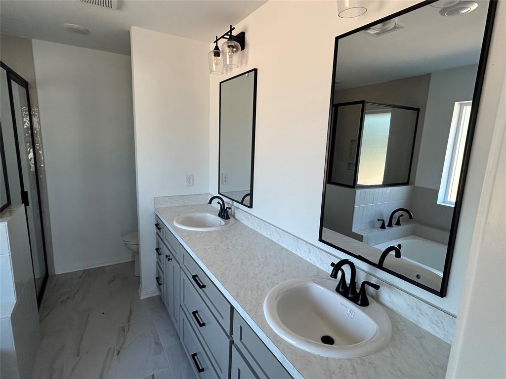 412 Conway Street Waco, TX 76705 - Photo 8 of 8 Full bathroom with double vanity, a garden tub, light marble finish floors, and a stall shower