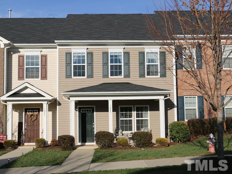 front view of a brick house with a yard