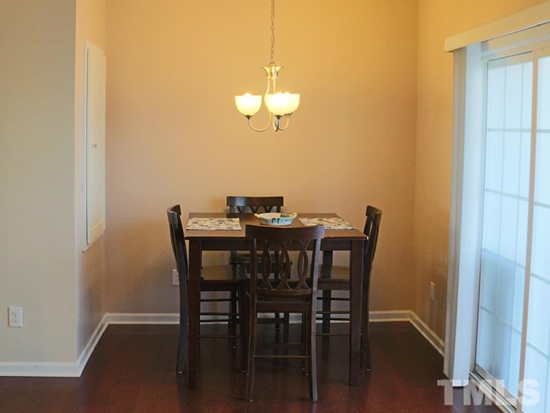 1045 Ileagnes Road Raleigh, NC 27603 - Photo 11 of 22 a view of a dining room with furniture and wooden floor