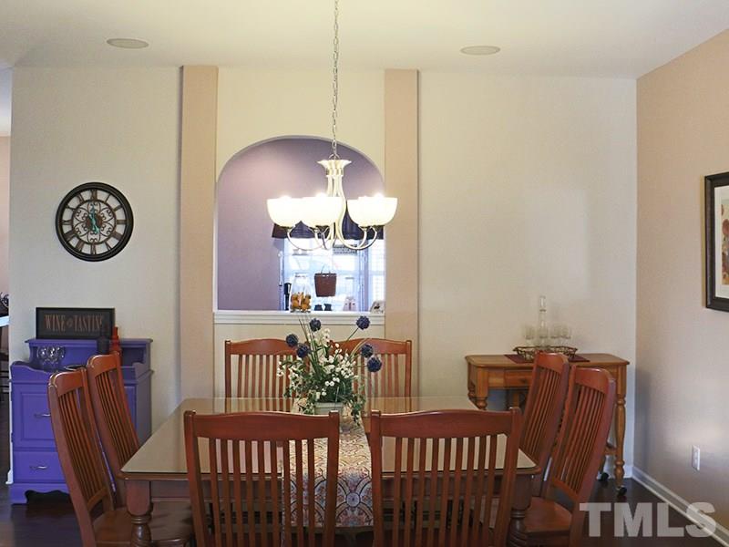 1045 Ileagnes Road Raleigh, NC 27603 - Photo 13 of 22 a view of a dining room with furniture and wooden floor