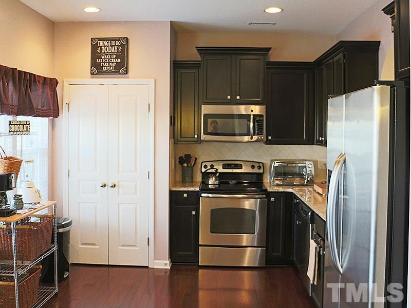 1045 Ileagnes Road Raleigh, NC 27603 - Photo 16 of 22 a kitchen with stainless steel appliances a refrigerator a stove a microwave and cabinets