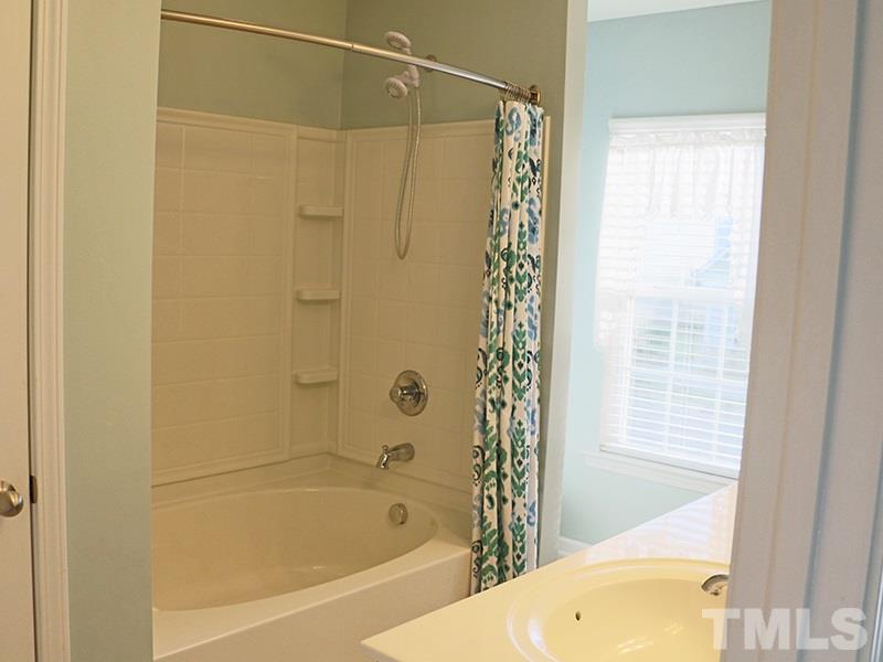 1045 Ileagnes Road Raleigh, NC 27603 - Photo 18 of 22 a bathroom with a shower and a bath tub