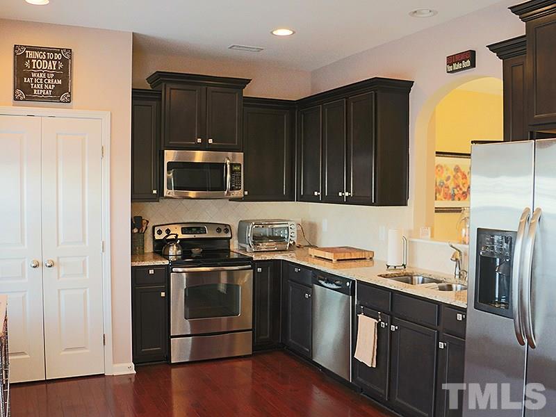 1045 Ileagnes Road Raleigh, NC 27603 - Photo 3 of 22 a kitchen with stainless steel appliances granite countertop a stove a refrigerator and a microwave