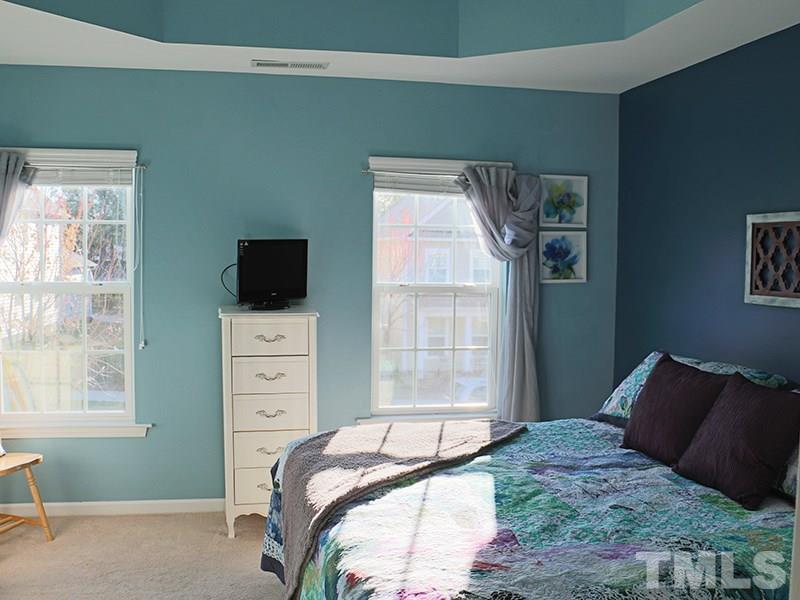 1045 Ileagnes Road Raleigh, NC 27603 - Photo 6 of 22 a bedroom with a bed and a television