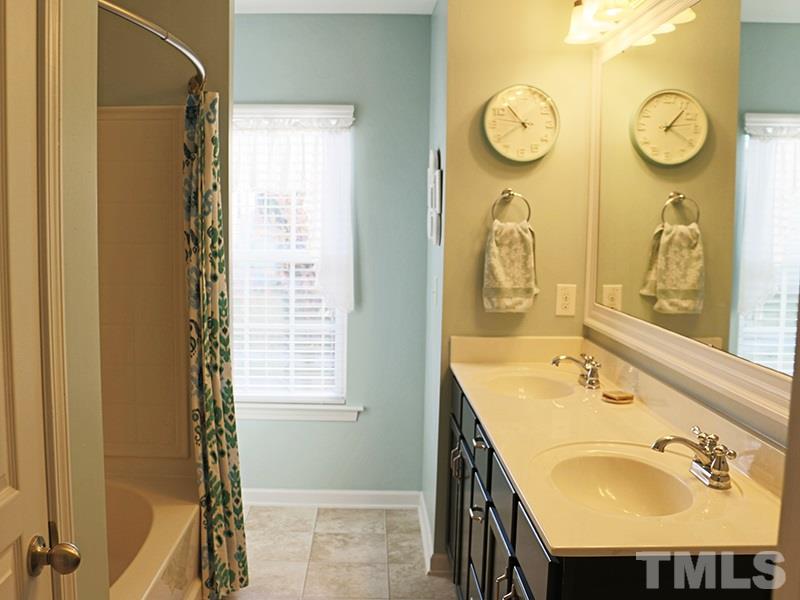 1045 Ileagnes Road Raleigh, NC 27603 - Photo 7 of 22 a bathroom with a sink and a mirror