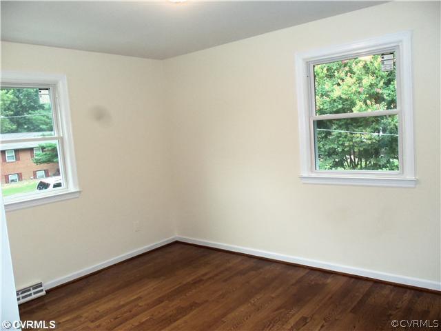 1209 Covington Road Colonial Heights, VA 23834 - Photo 11 of 12 an empty room with wooden floor and windows