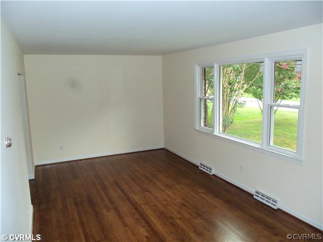 1209 Covington Road Colonial Heights, VA 23834 - Photo 12 of 12 a view of an empty room with wooden floor and a window