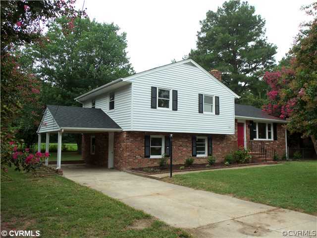 1209 Covington Road Colonial Heights, VA 23834 - Photo 2 of 12 a front view of a house with a garden