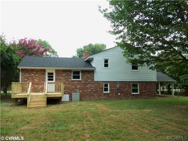 1209 Covington Road Colonial Heights, VA 23834 - Photo 3 of 12 a front view of a house with a garden