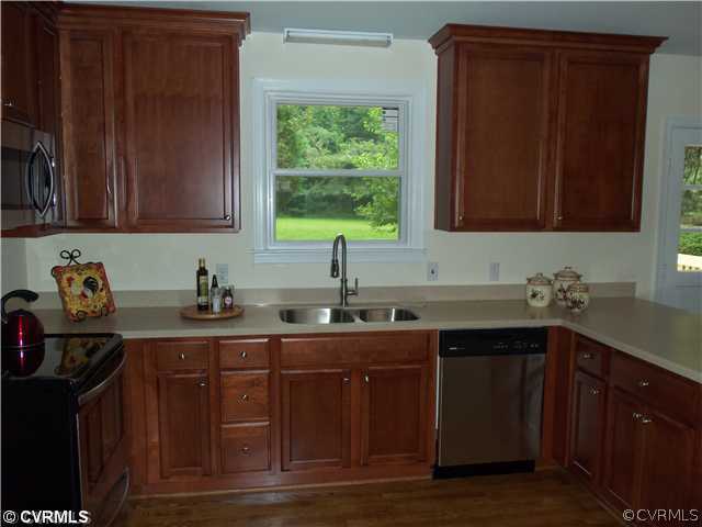 1209 Covington Road Colonial Heights, VA 23834 - Photo 4 of 12 a kitchen with sink cabinets and window
