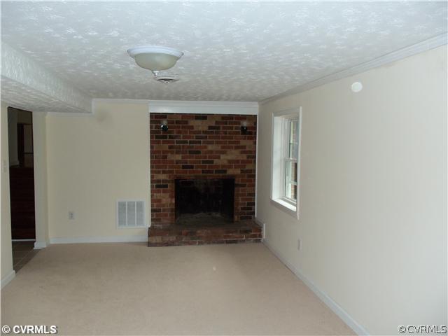 1209 Covington Road Colonial Heights, VA 23834 - Photo 6 of 12 a view of empty room with a fireplace