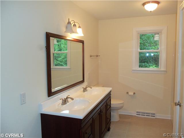1209 Covington Road Colonial Heights, VA 23834 - Photo 10 of 12 a bathroom with a sink and a mirror