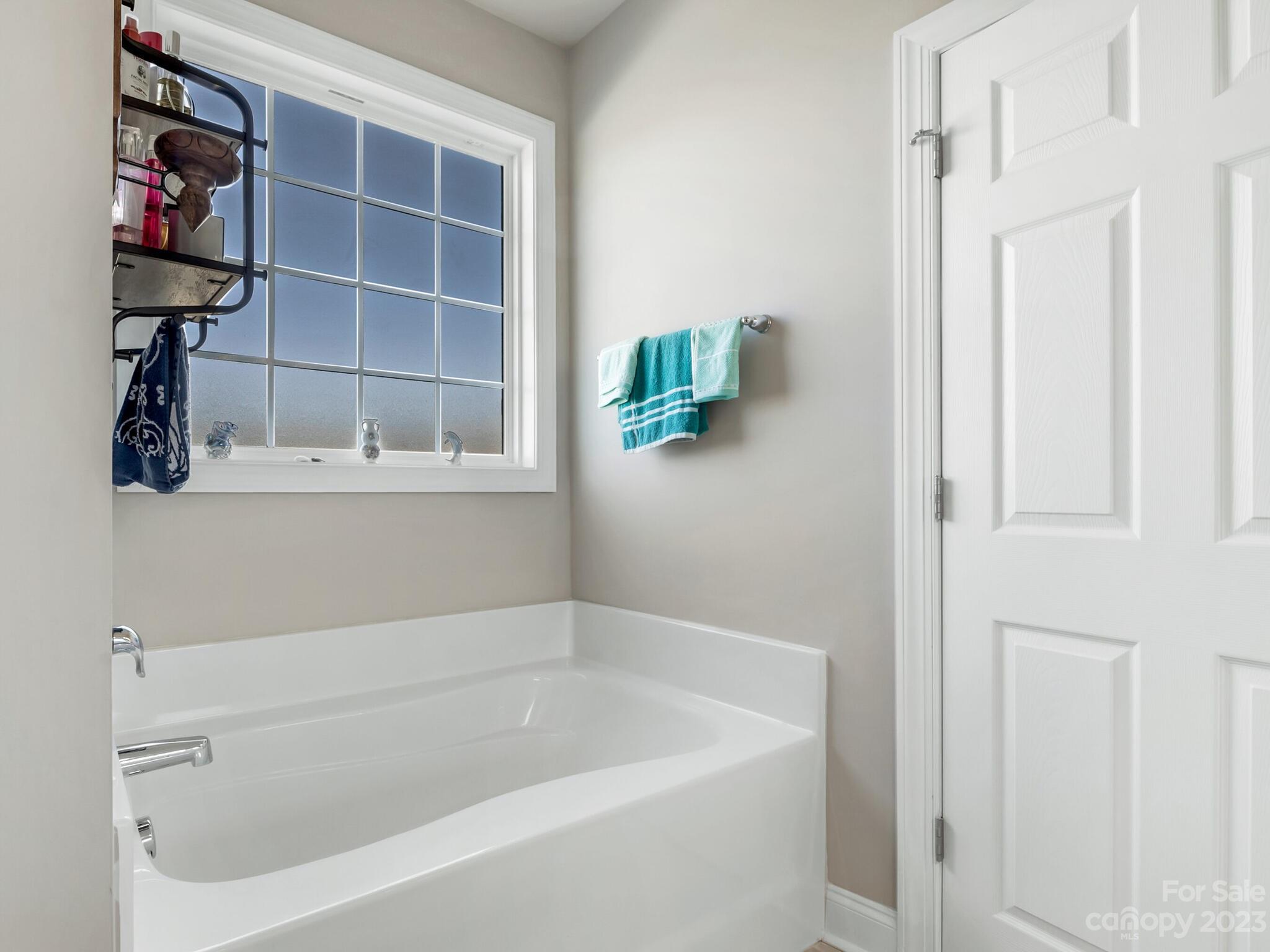 3324 Sincerity Road Monroe, NC 28110 - Photo 11 of 24 a white bath tub sitting next to a window