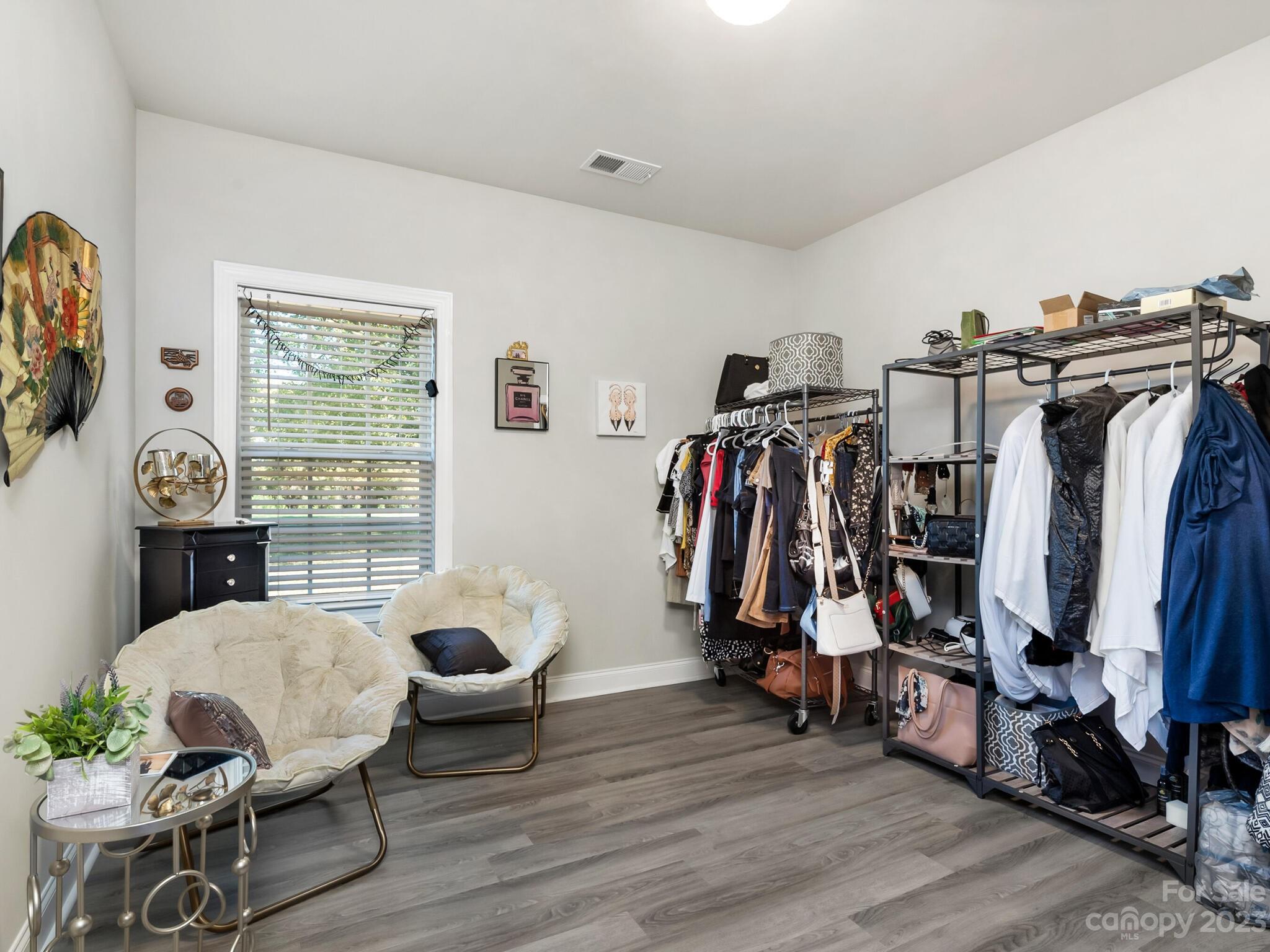 3324 Sincerity Road Monroe, NC 28110 - Photo 14 of 24 a view of walk in closet with clothes and shoes