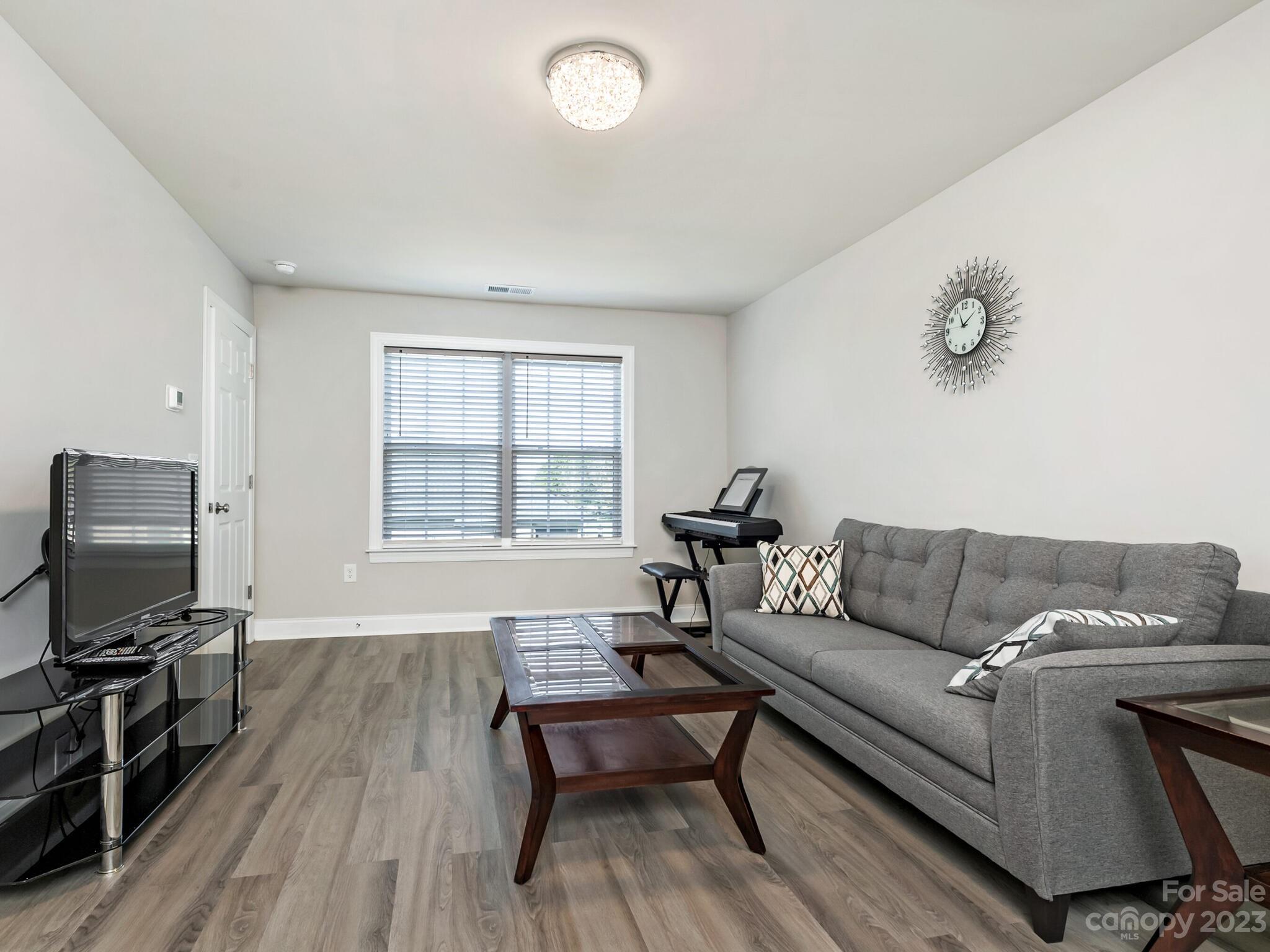 3324 Sincerity Road Monroe, NC 28110 - Photo 17 of 24 a living room with furniture and a flat screen tv
