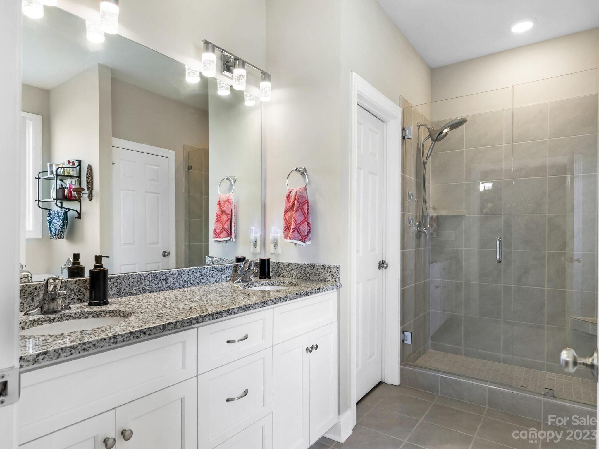 3324 Sincerity Road Monroe, NC 28110 - Photo 10 of 24 a bathroom with a granite countertop sink mirror and shower